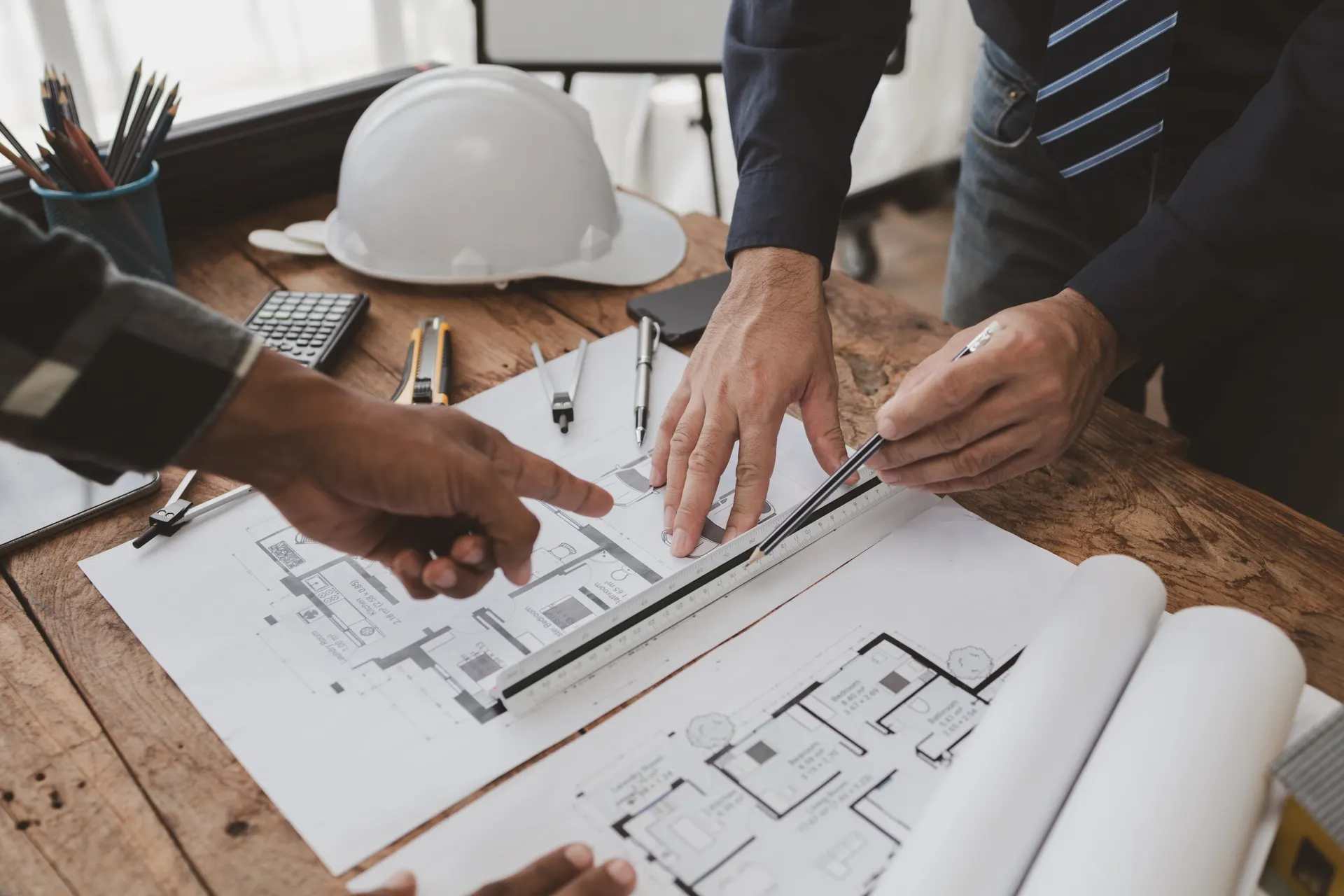 Architects working over technical drawings